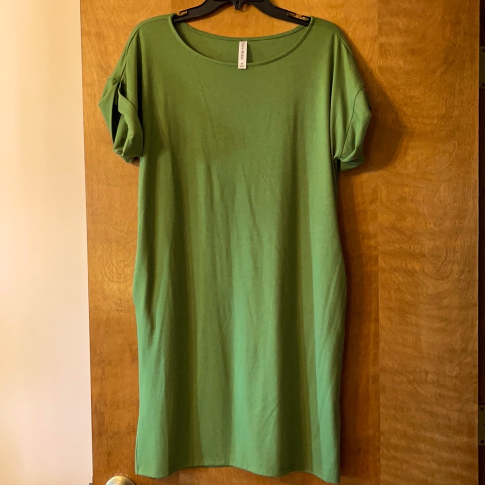 Green T-shirt dress with pockets.